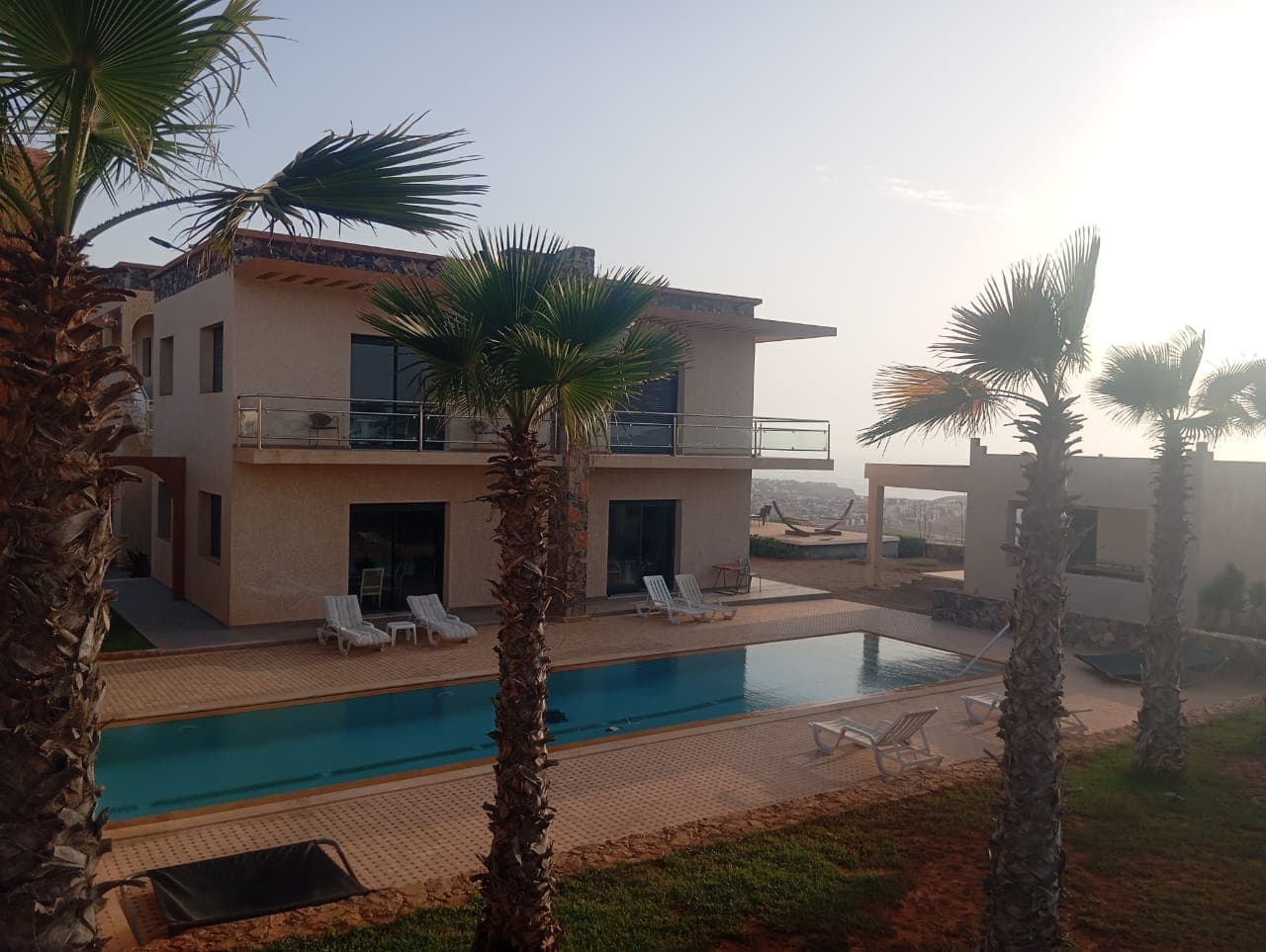 Hotel exterior showing modern architecture with swimming pool and landscaping