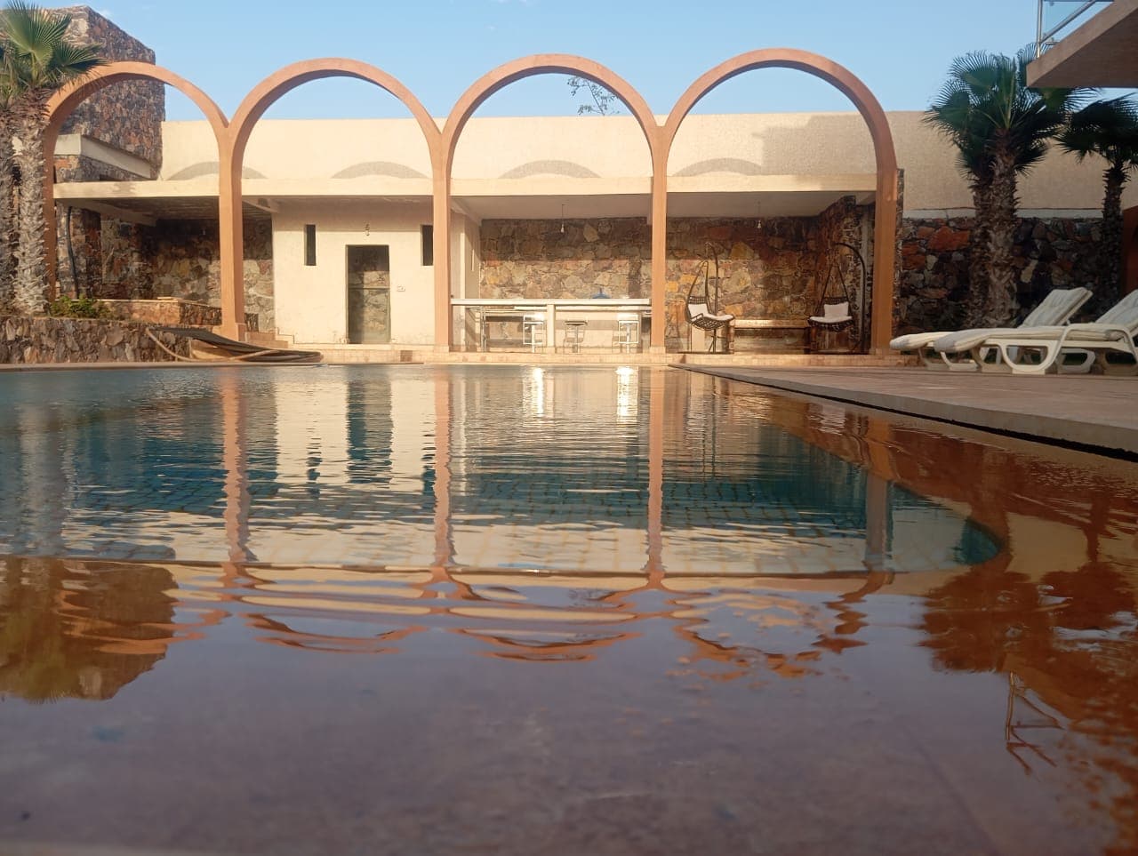 Spectacular pool reflection with traditional Moroccan arches