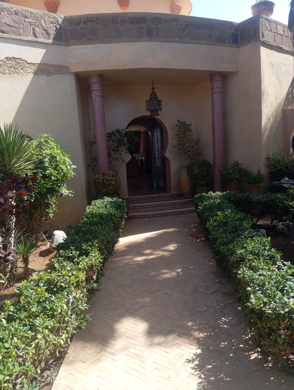 Villa's grand entrance with traditional Moroccan arched doorway