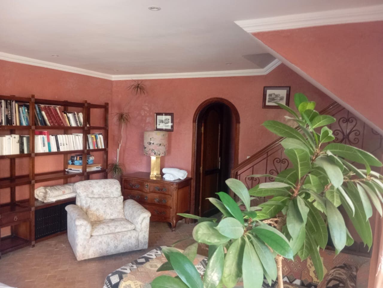 Villa library and living area with traditional staircase